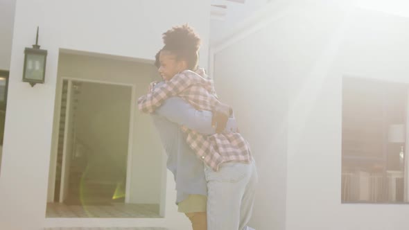 Video of happy african american couple embracing in front of new house