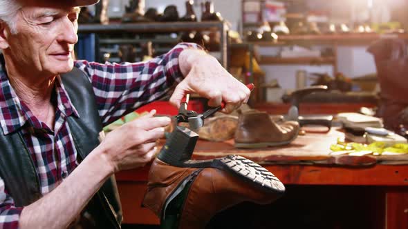 Shoemaker repairing a shoe