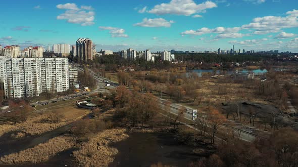 Aerial approach of a Highway near Kiev, small lake on both sides.