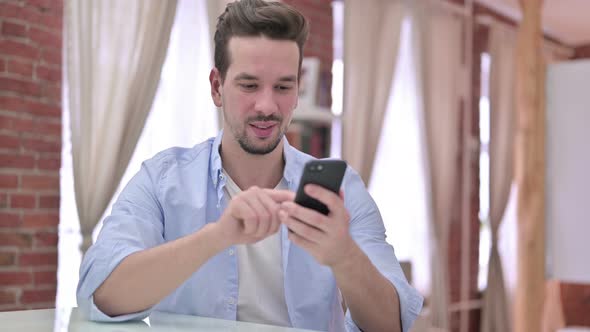 Ambitious Young Man Using Smartphone 