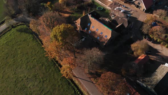 Aerial reveal of a biological dynamic farm in The Netherlands with a diversity of buildings, barns,