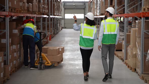 Couple of Engineers During Work in Factory Storage