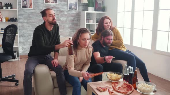 Group of Caucasian Friends Relaxing Watching Tv Sitting on Couch