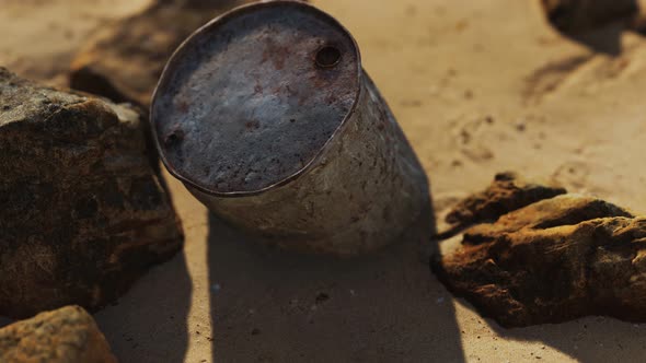 Rusty Metal Oil Barrel on Sand Beach