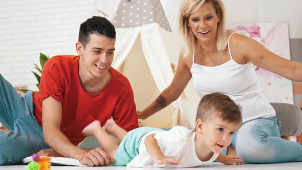 Cute Little Boy Playing with Parents Family Concept