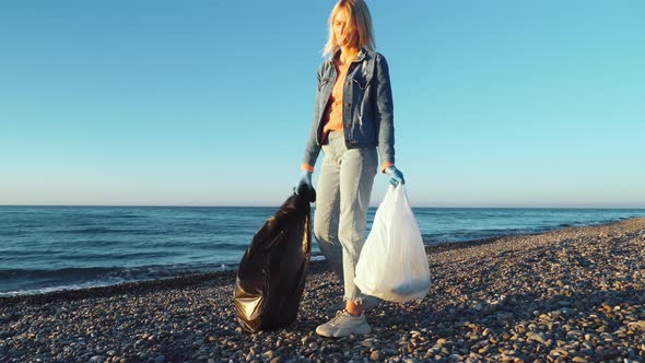 a woman collecting cleaning plastic bottles on the beach,