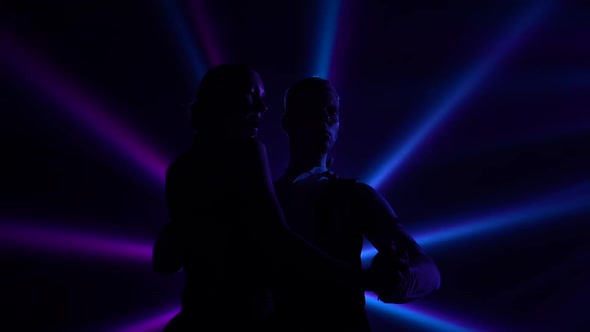 Bottom View of Black Silhouettes Dancing Couple Performing Elements of Argentine Tango