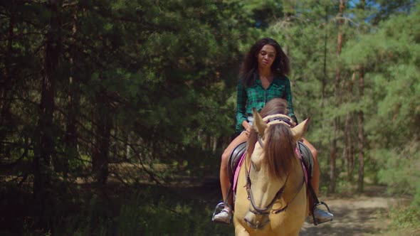 Pretty Woman Enjoying Horseback Riding Outdoors