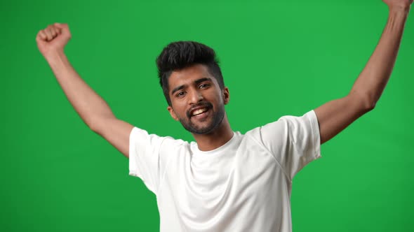 Excited Handsome Middle Eastern Football Player Gesturing Victory Posing on Green Screen