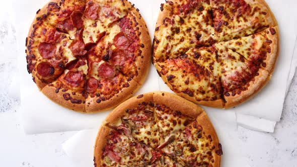 Three American Style Pizzas Served on a Table