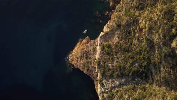 Top View of a Golden Rocks with a Little Boat on South Coast of France at Sunset