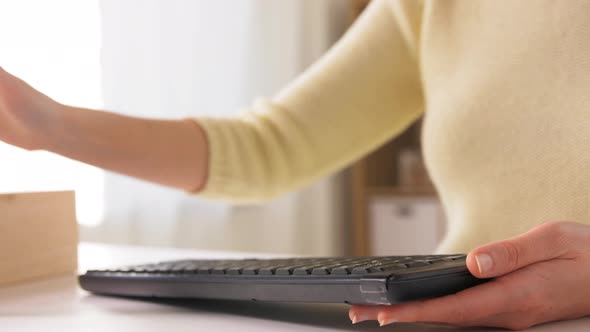 Close Up of Woman Cleaning Keyboard with Sanitizer