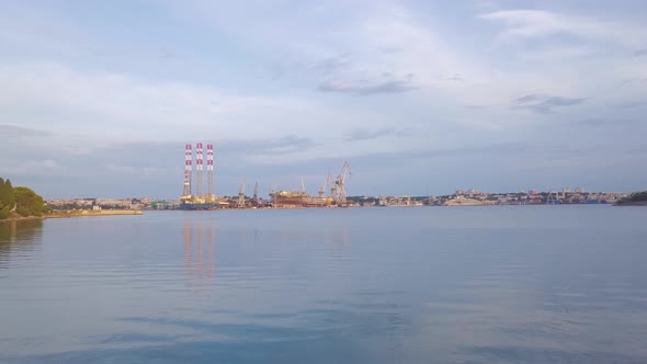 Water Surface With Shipyard On Background