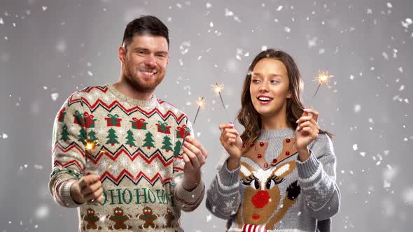 Happy Couple with Sparklers at Christmas Party