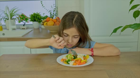 The Child Eats Boiled Vegetables