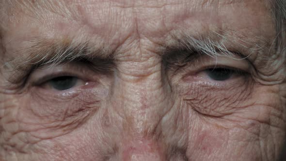Close Up Of Eyes Of An Old Elderly Woman With Deep Wrinkles And A Nervous Tic