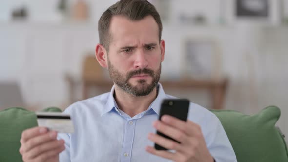 Man Reacting To Online Shopping Problem on Smartphone