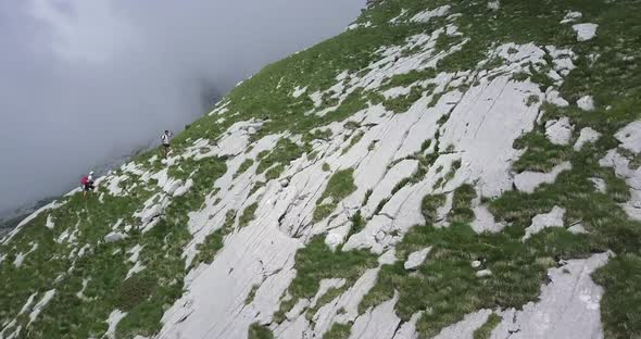 Aerial drone view of hikers hiking in the mountains