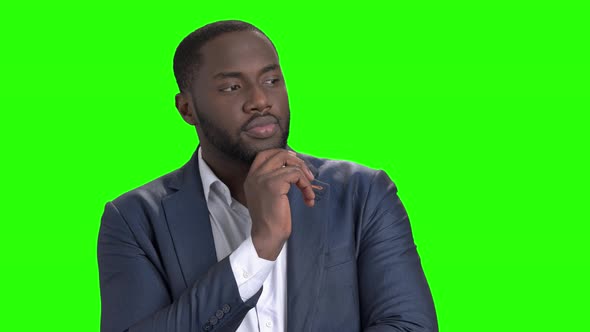 Afro-american Businessman Is Thinking on Green Screen.
