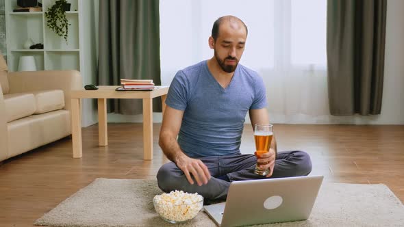 Man with Beer and Popcorn on Video Call