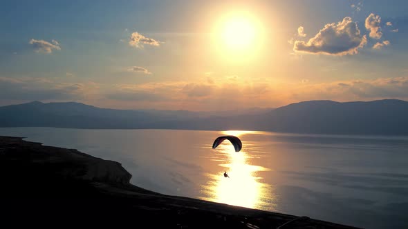 Silhouette of Parachute on Sunset Background