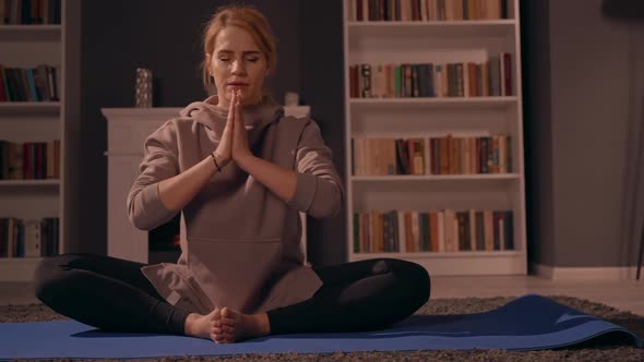 Female Doing Yoga in Living Room