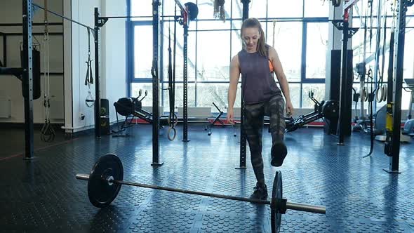 Muscular Sports Woman Finish to Work Out in the Gym Lifting Weights.