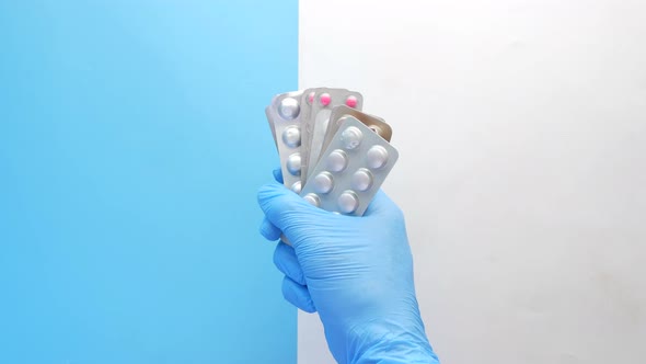 Doctor Hand in Latex Gloves Holding Blister Pack Close Up