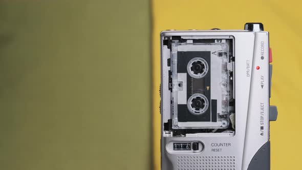 Portable Retro Tape Recorder with Micro Cassette Rec Sound on Yellow Background