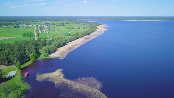 Aerial panorama view of a Lake Usma (Latvia) on a sunny summer day, distant islands with lush green