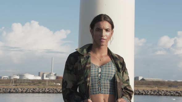 Woman In Camouflage Jacket Posing On Pier