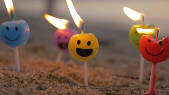 Colorful Smiley Candles on the Beach