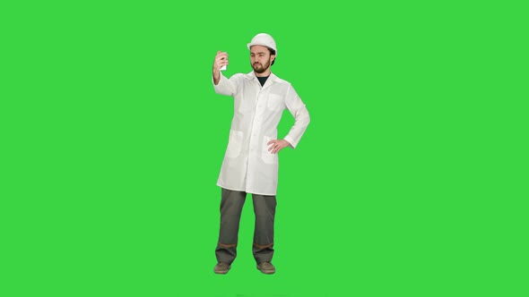 Engineer or Architect Taking a Selfie Showing Gesture on a Green Screen, Chroma Key