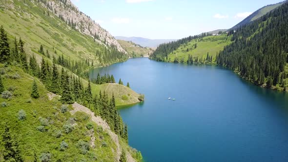 Kolsay Lake Among Green Hills and Mountains