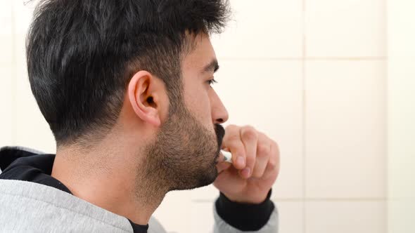 Man brushing his teeth.