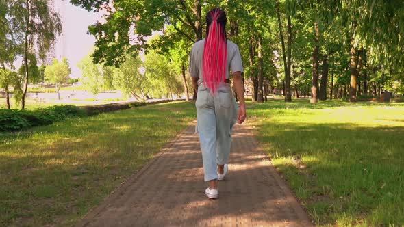 Back View Woman Walks in City