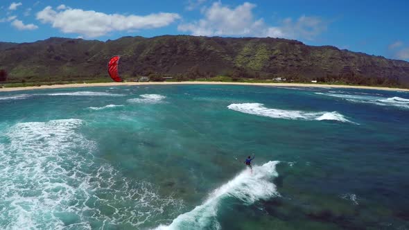 Aerial view of a man kitesurfing in Hawaii