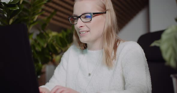 Woman Working on Laptop at Home Office