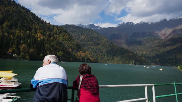 Elderly Man and Woman Tourists on Sightseeing at Mountain Lake Natural Resort