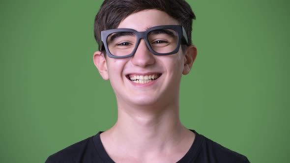 Young Handsome Iranian Teenage Boy Against Green Background