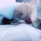 Surgeon's hand performing operation in bloody gloves - VideoHive Item for Sale