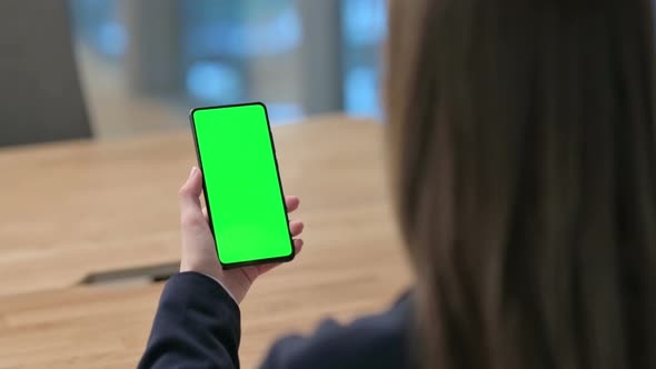 Rear View of  Businesswoman using Smartphone with Green Chroma Key Screen 