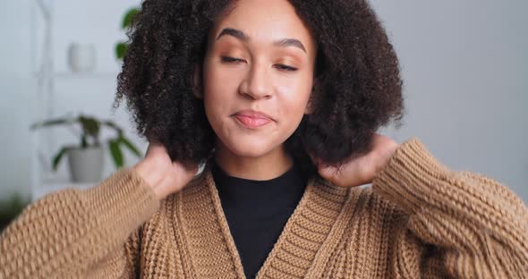 Portrait of Woman Model Afro American Girl Straightens Curly Hair Touches Hairstyle with Her Hands