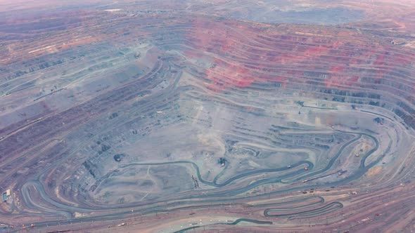 Aerial View of Opencast Mining Quarry with Lots of Machinery at Work - View From Above.