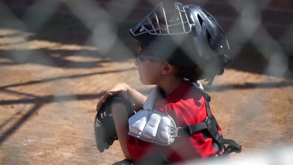 Close-up of a boy playing catcher for a little league baseball team.