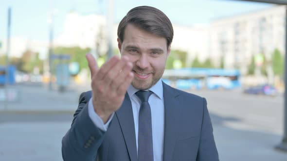 Businessman Pointing at the Camera and Inviting Outdoor