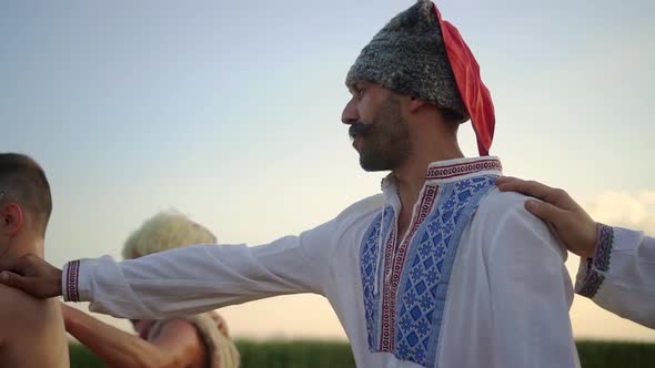 Ukrainian Cossacks Sing a Song in a Field at Sunset