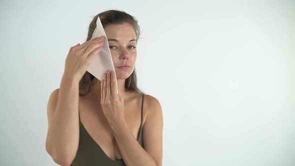 The Girl Removes the Mask From Her Face with a Sponge