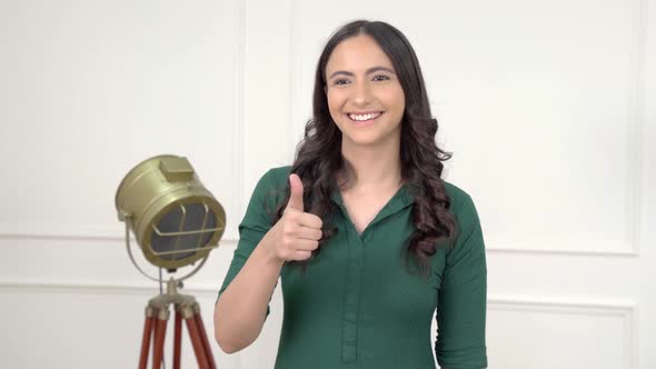 Indian girl showing Thumbs up