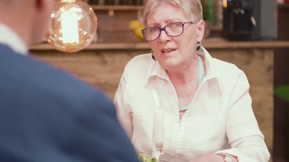 Over the Shoulder Shot of a Old Woman Having a Conversation